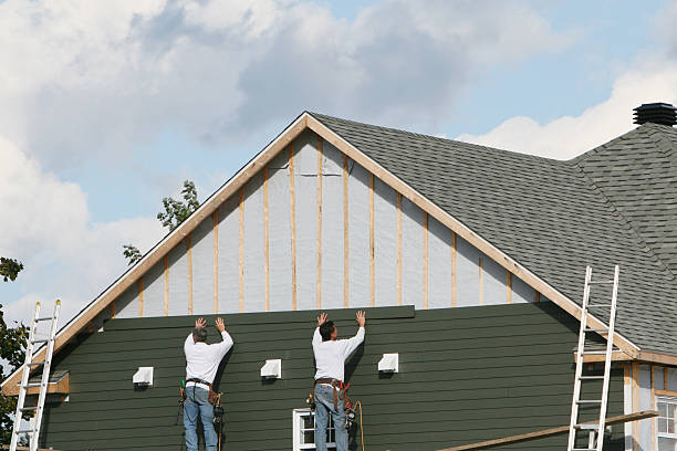 Professional Storm Damage Siding Repair technician working in Dysart, PA